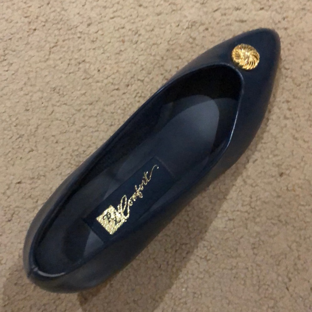 Navy blue leather pumps with gold swirl button
